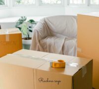 A picture of boxes and a sofa visible for moving